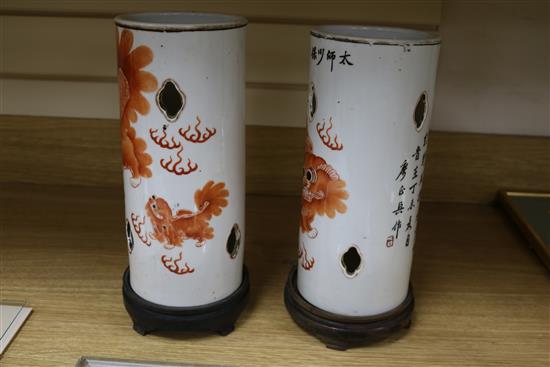 A pair of early 20th century Chinese lion-dog porcelain hat stands total height including stands 31.5cm